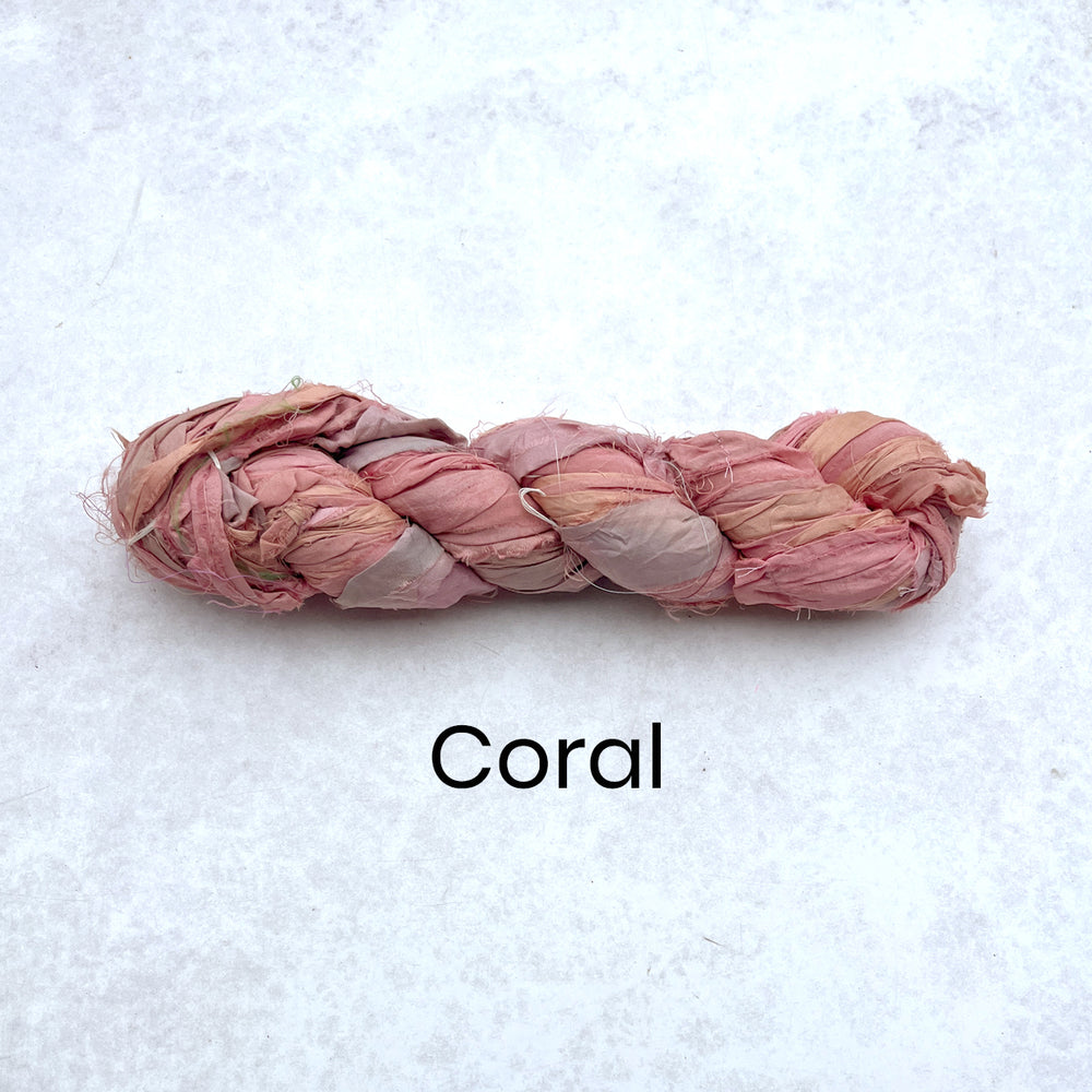 Thin strip of silk sari silk ribbon in a 100g skein coral
