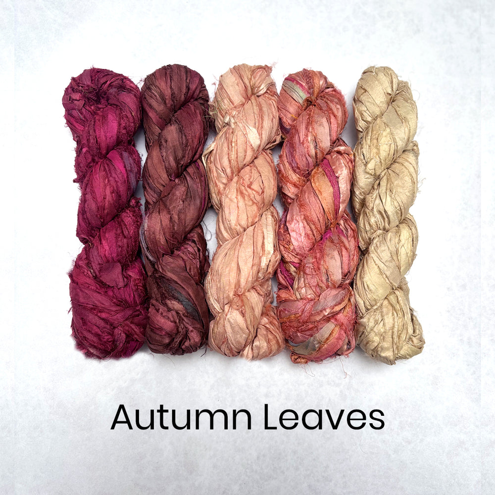 Five braided silk sari strip skeins in autumn leaf colors on a white background with 'Autumn Leaves' text