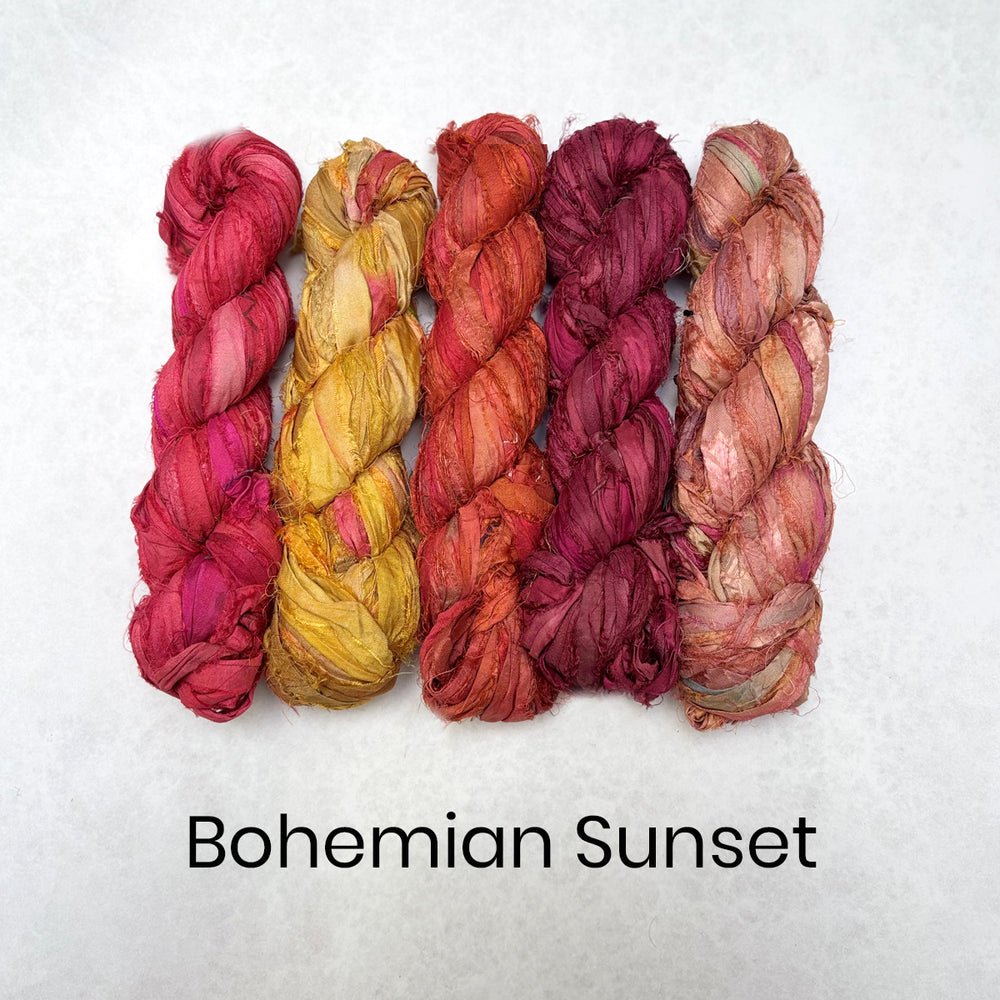 Five skeins of sari silk fabric strips in pink, orange, and red shades on a white background with 'Bohemian Sunset' text.