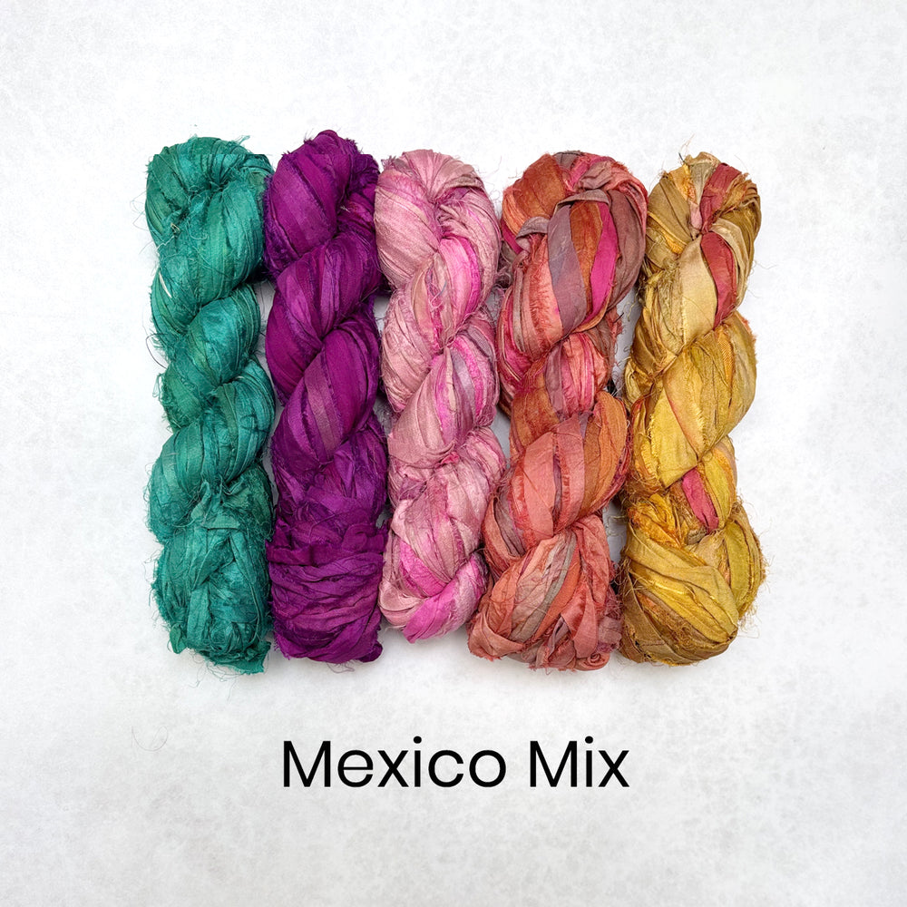 Five skeins of colorful silk in shades of green, purple, pink, orange, and yellow on a white background with 'Mexico Mix' text.