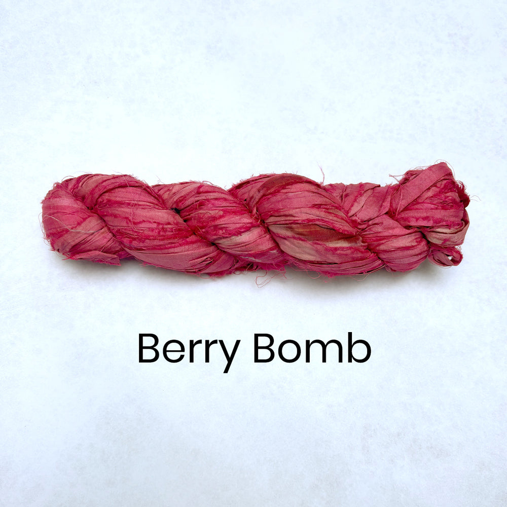 Wound up skein of sari silk strips in bright pink berry bomb colour