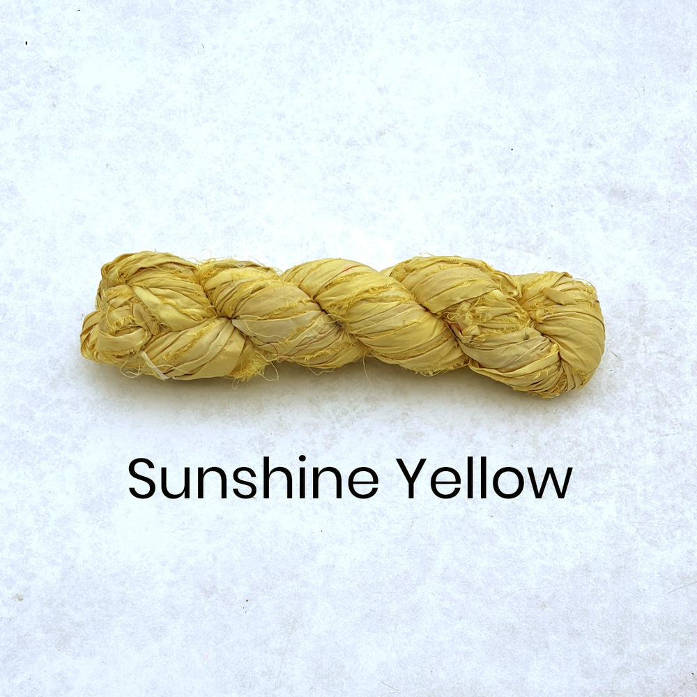 Bright yellow sari silk ribbon strips for rug making and textile crafts