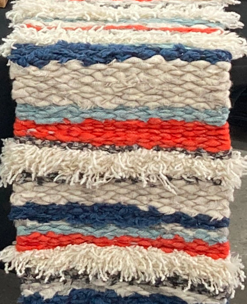 orange and blue stripey rag rug made on a 90cm long wooden peg loom with cream fluffy textured trim by Ragged Life
