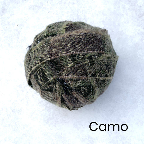 A selection of green Wool Blanket Selvedge Edges balled up for rag rug making - Ragged Life Blanket Yarn