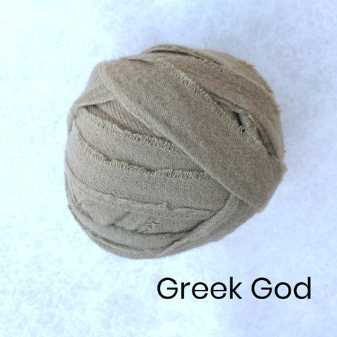 A selection of green Wool Blanket Selvedge Edges balled up for rag rug making - Ragged Life Blanket Yarn