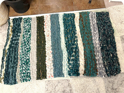 Green striped peg loom weaving made by student Linda