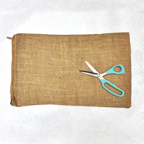 Group of colourful rag rug cushions on a red sofa