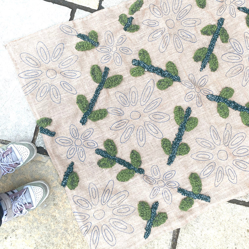 Decorative mat with floral patterns on a stone surface