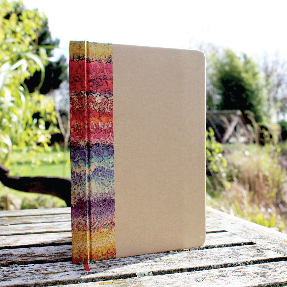 Ragged Life hardback notebook with brown cover and colourful rainbow rag rug image