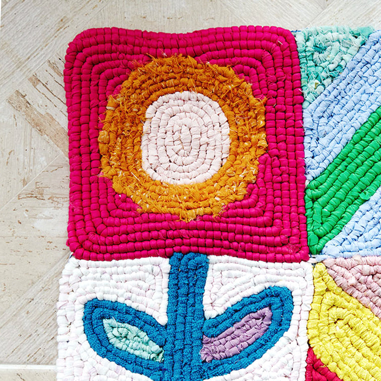 Colourful locker hooked circle and flower done on rug canvas