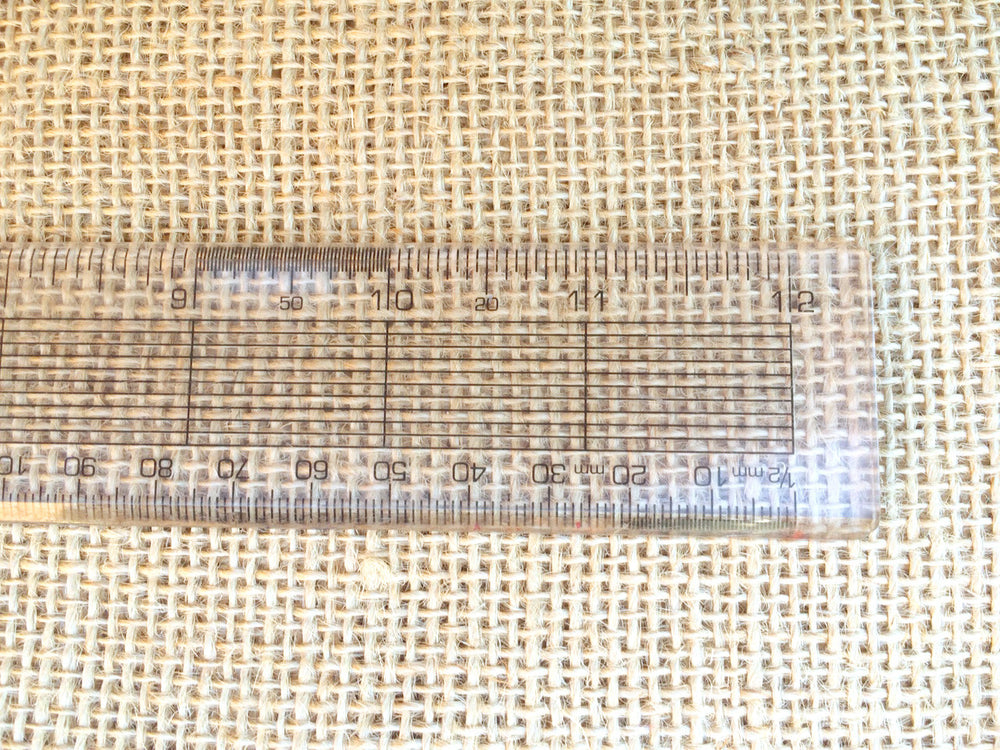 Hessian with a ruler to show the weave needed for rag rugging