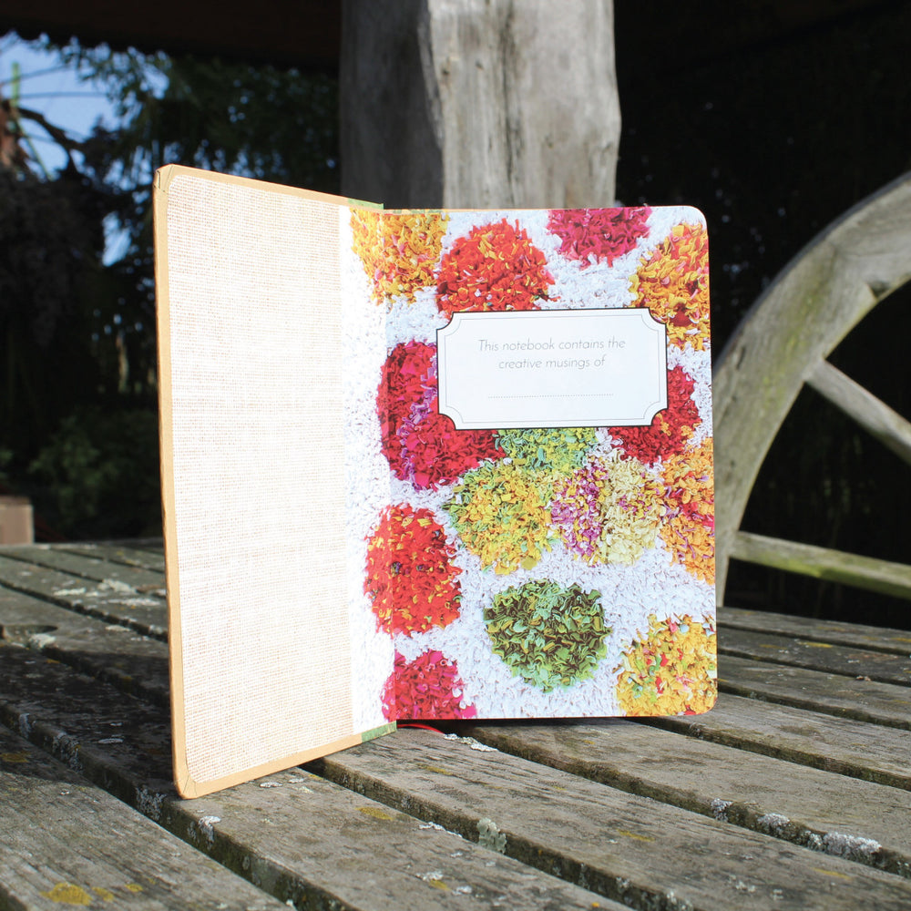 Ragged Life hardback notebook open with lined paper and a colourful shaggy polka dot rag rug image