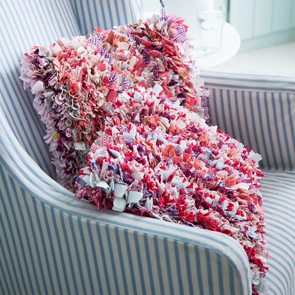 Pink fluffy rag rug cushion made using recycled materials