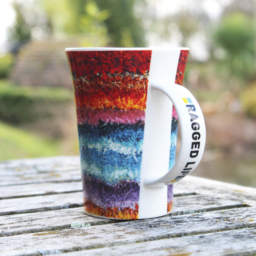 Ragged Life large mug with a rainbow stripe shaggy rag rug image